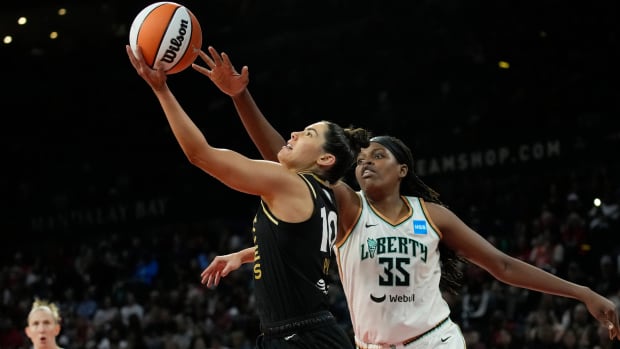 Las Vegas Aces guard Kelsey Plum shoots around New York Liberty forward Jonquel Jones (35) during the WNBA Finals.